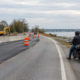 Motorcycle accident construction zone Maryland scene with temporary barriers and a rider observing safely