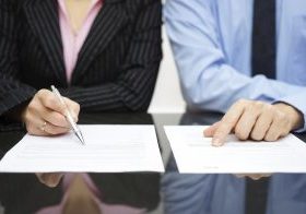 businessman and businesswoman are inspecting contract